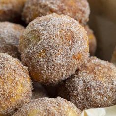 powdered sugar covered donuts sitting in a basket