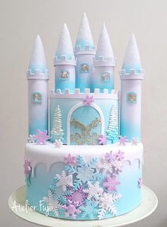 there is a cake that has frosting on it with snowflakes and princess castle