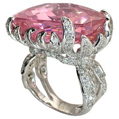 Indulge in luxury with our 18k Diamond and Pink Stone Center Cocktail Ring. The 50.47 carat pink stone takes center stage, surrounded by 1.10 carats of diamonds. Crafted from 18k white gold, this ring exudes sophistication and elegance. In good condition with minor surface wear, this 22.3 gram piece is marked for authenticity. Available in size 6.25. 18k Diamond and Pink Stone Center Cocktail Ring Condition: In good condition with some minor surface wear consistent with age. Ring size: 6.25 Markings: "750” Metal: 18k White Gold Weight: 22.3 grams Diamonds: 1.10 carats  Pink Center Stone: 50.47 carats Cocktail Rings Diamond, Pink Diamond Ring, Diamond Cocktail Rings, Animal House, Pink Stone, Center Stage, Cocktail Ring, Cocktail Rings, Diamond Rings