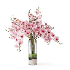 a vase filled with lots of pink flowers on top of a white table next to a wall