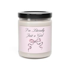 a candle that says i'm currently just a girl on the front and side