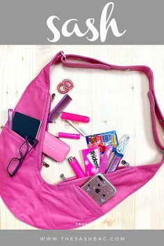 a pink purse filled with personal items on top of a wooden table next to the words sash