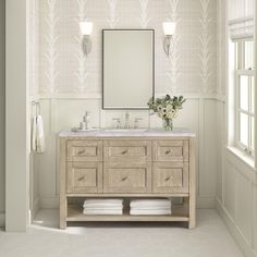 a bathroom vanity with two sinks and a mirror