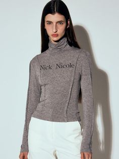 This is NICK&NICOLE’s unique look with pin tuck detailing on the turtleneck. It's a versatile item that can be worn alone or as a layering piece. With its slim silhouette, it offers various styling options.- Ideal for daily wear- Can be paired with different styles of bottoms for versatile styling- The brand logo is printed on the front, adding a focal point Gray High Neck Tops For Layering, Chic Gray Turtleneck Top, Gray Turtleneck Top For Layering, Gray Funnel Neck Top For Layering, Turtleneck Top, Turtle Neck Top, Pin Tucks, Layering Pieces, Different Styles