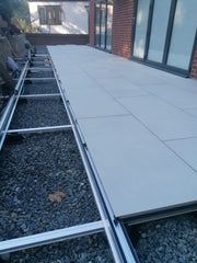 an outdoor patio being installed on the side of a building