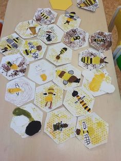 bees and honeycombs cut out from paper on a table