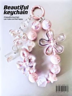 the front cover of beautiful keychain magazine featuring pink beads and flowers on it