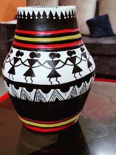 a black and white vase sitting on top of a table