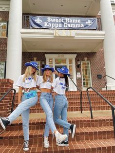 three young women sitting on the steps in front of a building with a sign that says sweet home kelpia campus