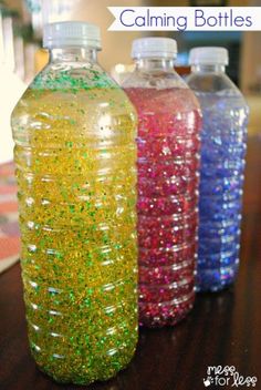 two plastic bottles filled with liquid sitting next to each other