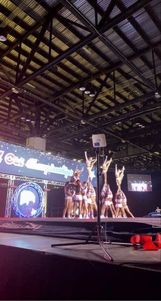 a group of people standing on top of a stage in front of a basketball hoop