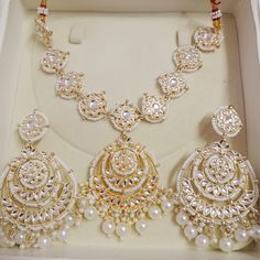 Title: "Exquisite Indian Jewelry: Kundan Necklace Set for Bridal Elegance" Step into the enchanting world of Indian tradition with our Kundan Necklace Set, meticulously crafted to adorn you with timeless elegance and grace. Inspired by the opulence of Indian weddings and the richness of ethnic bridal attire, this exquisite ensemble is a tribute to the beauty of tradition and culture. Indulge in the allure of our Ethnic Bridal Necklace, meticulously designed to complement your bridal attire with Silver Kundan Set For Eid, White Jhumkas For Wedding And Eid, Gold Bridal Sets With Mirror Work For Festive Occasion, White Chandbalis For Eid Celebration, Festive Gold Bridal Set With Mirror Work, Round Wedding Tikka For Festivals, Kundan Sets For Eid Gift, White Chandbali Jewelry Sets For Eid, Bollywood Style White Jewelry Sets For Eid