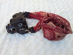 a camera with a red scarf around it