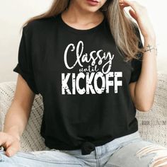 Listing:(1) Classy until Kickoff Shirt Cheer on your favorite team during game days with this cute Classy until Kickoff Shirt.  Main listing photo: Black shirt with white lettering.  Following listing photos... Heather maroon, heather red, heather navy, deep heather and white tops. All tops feature black and white lettering.  Branding:  Adult: Bella Canvas *Sizing is unisex  *Size chart available in the photos section Care Instructions:  Turn inside out wash on gentle & dry on low.  I use high q Casual Letter Print Shirt For Football Season, Casual Text Print Tops For Football Season, Casual Tops With Team Name For Cheerleading, Casual Team Name Tops For Cheerleading, Casual Tops For Cheerleading With Team Name, Black Top With Letter Print For Cheerleading, Casual Tops With Logo Print For Game Day, Casual Game Day Tops With Logo Print, Casual Letter Print Shirt For Sports Season