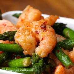 shrimp and asparagus in a white square dish