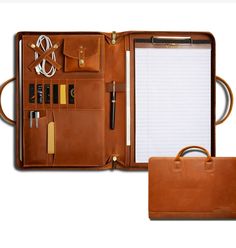 an open brown leather briefcase with notepad and pen