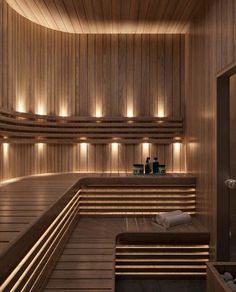 a sauna room with wooden walls and benches