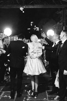 black and white photograph of people at a party with confetti thrown in the air