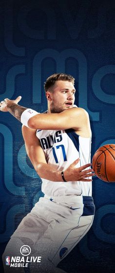 a man holding a basketball in his right hand while wearing a white jersey and blue shorts