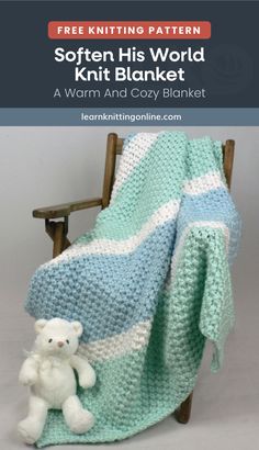 a white teddy bear sitting next to a blue and white blanket on a wooden chair