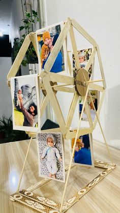 a wooden structure with pictures on it sitting on a table