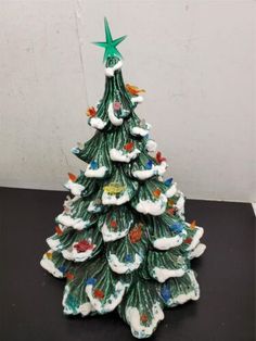 a small ceramic christmas tree on a table