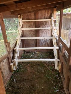 the inside of a chicken coop with wooden slats