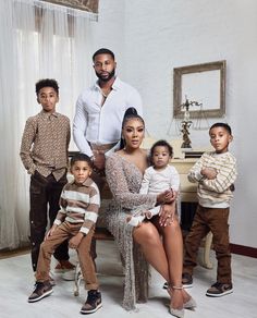 the family is posing for a photo in their living room