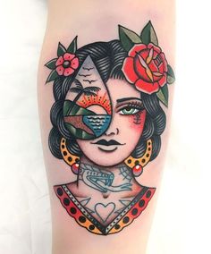 a woman's face with flowers and birds on her head is shown in this tattoo design