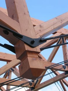 the wooden structure is being constructed with metal straps