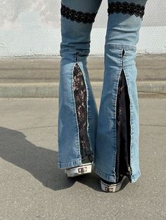 a person wearing high heels and jeans with lace on them