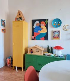 a child's room with yellow lockers and pictures on the wall