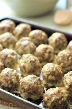 some meatballs are in a pan on a table