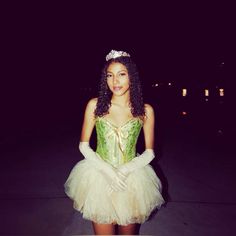 a woman dressed in a green and white costume