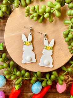 the bunny earrings are on display next to some vegetables