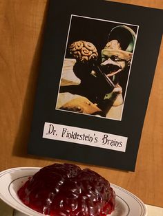 there is a jelly cake on the table with a sign above it that says dr follflesten's bros