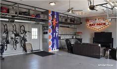 a garage with bikes hanging from the ceiling and a couch in front of it,