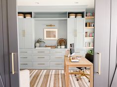 a desk and chair in a room with built - in bookshelves on the wall