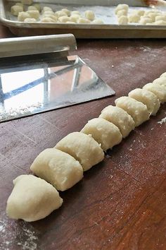 dough is being prepared on a wooden table