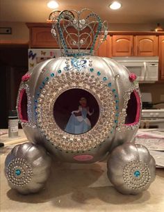 a silver carriage with a princess on it's face in the middle of a kitchen