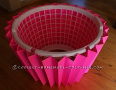 a pink vase sitting on top of a wooden floor