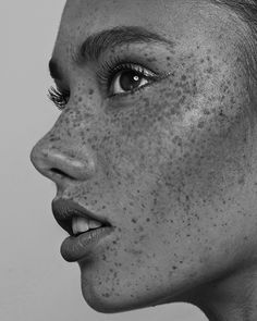 a woman with freckles on her face