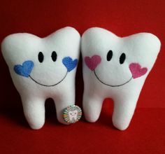 two stuffed toothbrushes with hearts on them