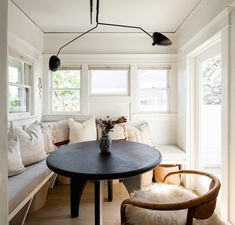 a black table sitting in the middle of a living room