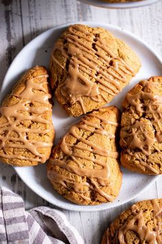 several cookies with frosting on a white plate