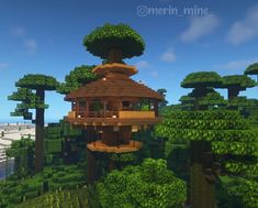 an image of a tree house in the middle of some trees and bushes on top of it