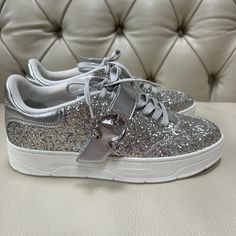 Beautiful Brand New Jimmy Choo Silver Sneakers Made Of Leather And Covered In Glitter With Gems, Size 38 Or 7.5, Made In Italy, I No Longer Have A Box. Everything In My Closet Is Authentic And Pm Will Authenticate It For You For Free, Enjoy! Low-top Leather Sneakers With Glitter Accents, Embellished Leather Sneakers With Round Toe, Low-top Leather Glitter Sneakers, Embellished Low-top Party Sneakers, Embellished Low-top Sneakers For Party, Silver Embellished Sneakers With Round Toe, Silver Embellished Round Toe Sneakers, Embellished Leather Sneakers, Party Low-top Sneakers