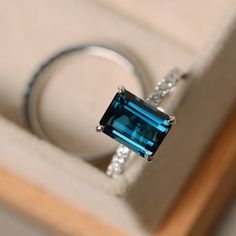 This ring features a 7*9mm emerald cut London blue topaz and sterling silver finished with rhodium. Customization is available. It is made by hand, and it will take about 7 days to finish the ring after your payment is completed. Main stone: London blue topaz London blue topaz weight: Approx 3.15 ct London Blue Topaz Engagement Rings, November Birthstone Ring, Blue Topaz Engagement Ring, Topaz Engagement Ring, London Blue Topaz Ring, November Birthstone, Ring Blue, Silver Engagement Rings, Emerald Engagement Ring