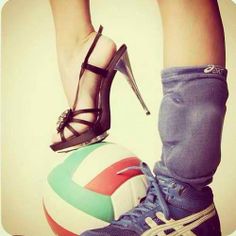 a woman's legs with high heels standing on top of a colorful soccer ball