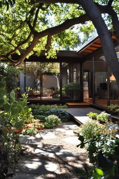 a house that is surrounded by trees and plants